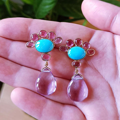 Close-up of handcrafted Atlantis Heiress earrings in gold